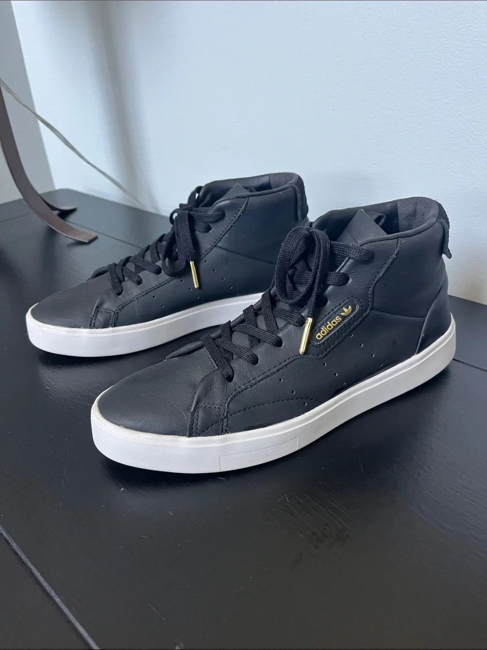 Adidas W/7.5 Black High-Top Sneakers/ white sole and gold logo.
